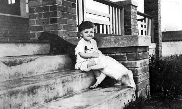 Child with two puppies.
