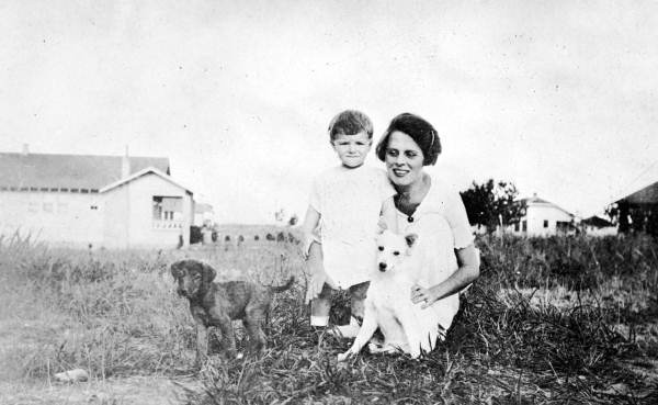 Woman and child with two puppies.