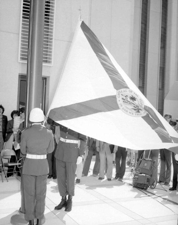 Raising the flag of the State of Florida at dedication ceremony.