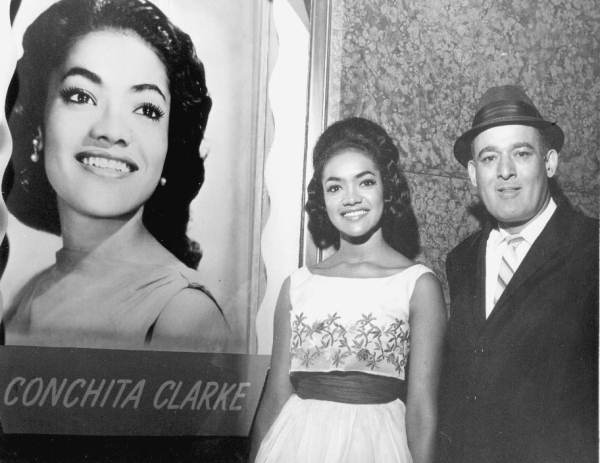 Conchita Clarke next to her billboard announcement