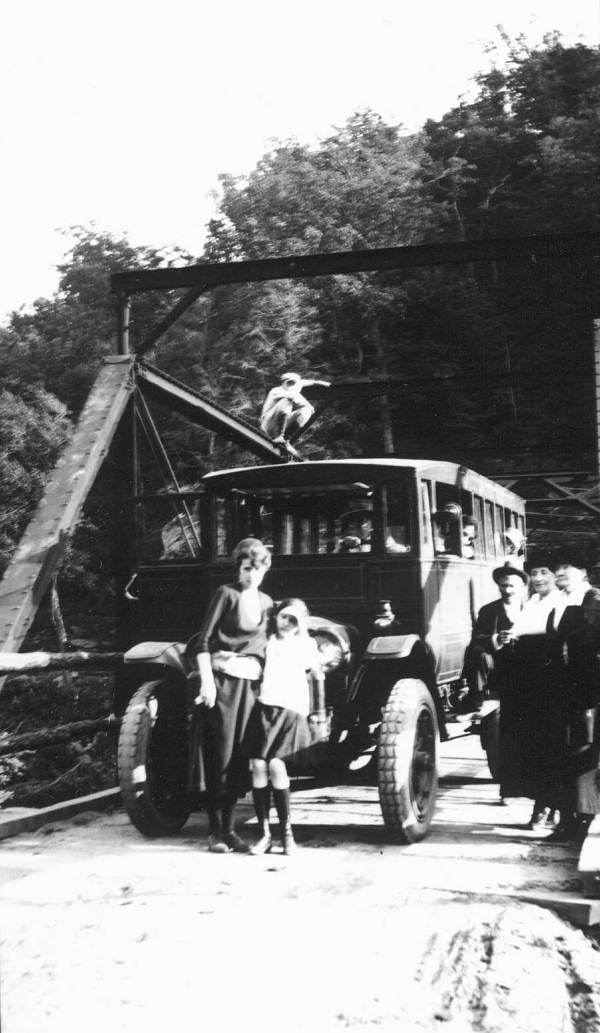 People standing near an antique car