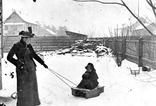 Woman pulling a sled with child - De Land, Florida