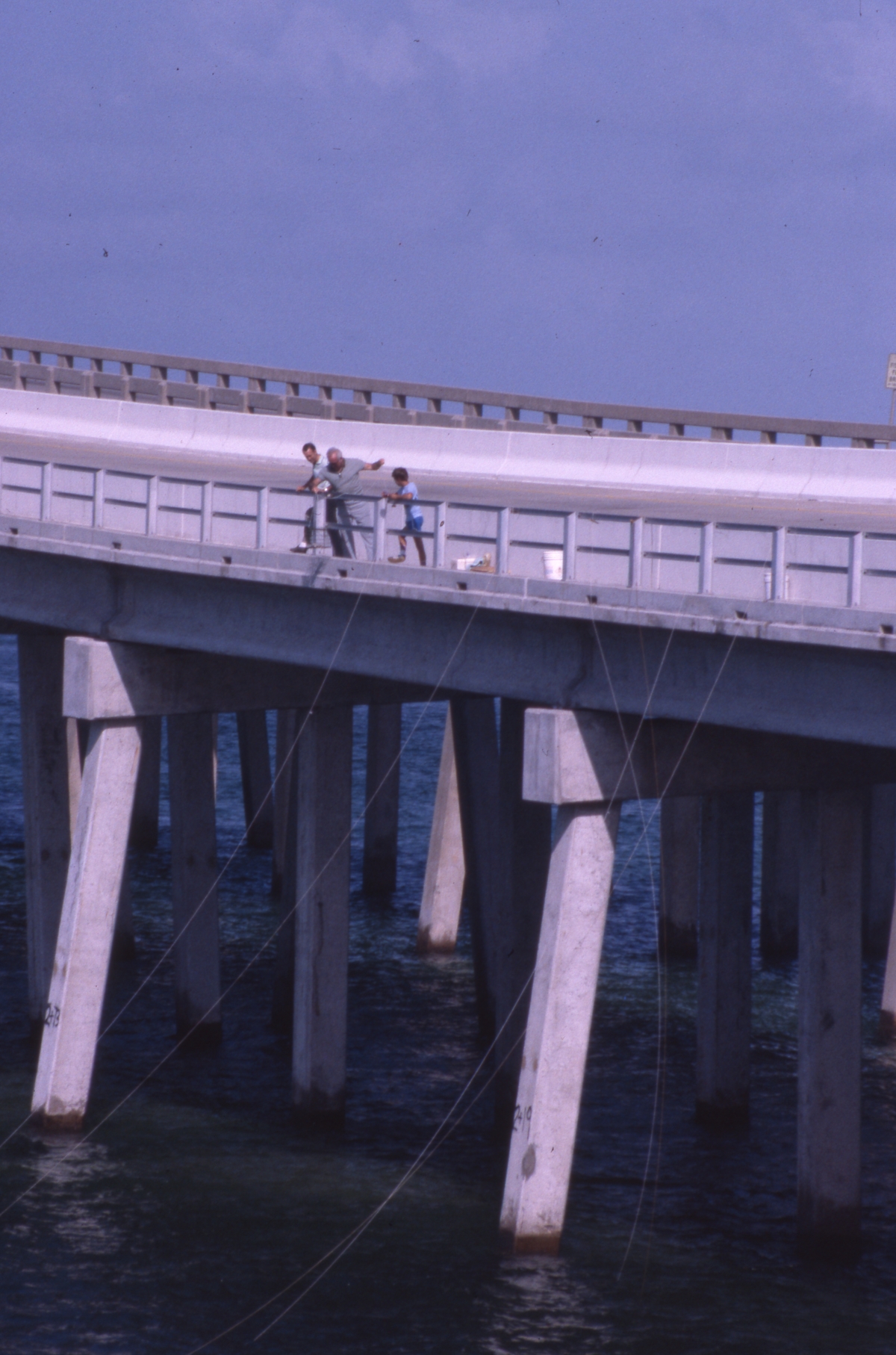 People crabbing in the East Pass channel from bridge - Destin, Florida