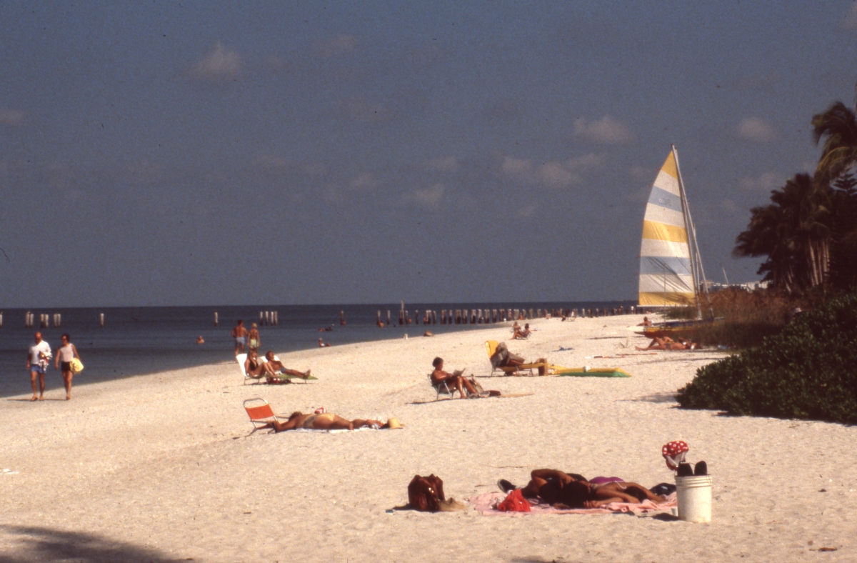 Sunbathers enjoying the day at the beach - Naples, Florida.