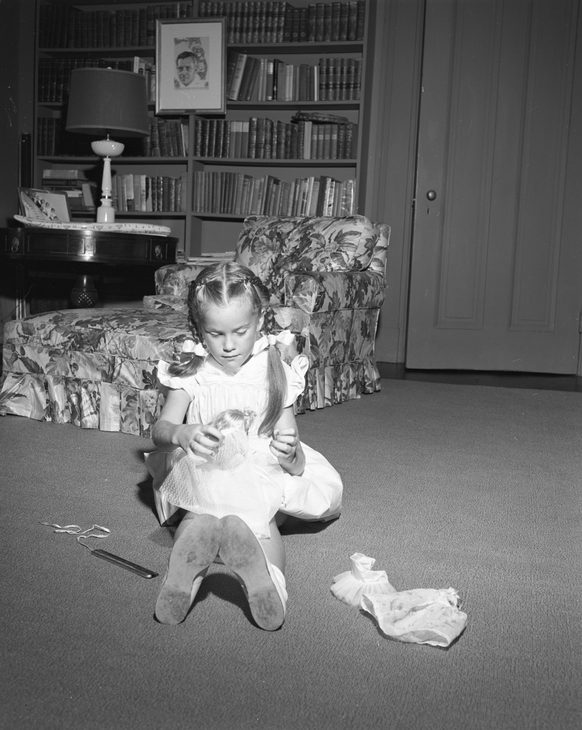 Darby Collins playing with a doll