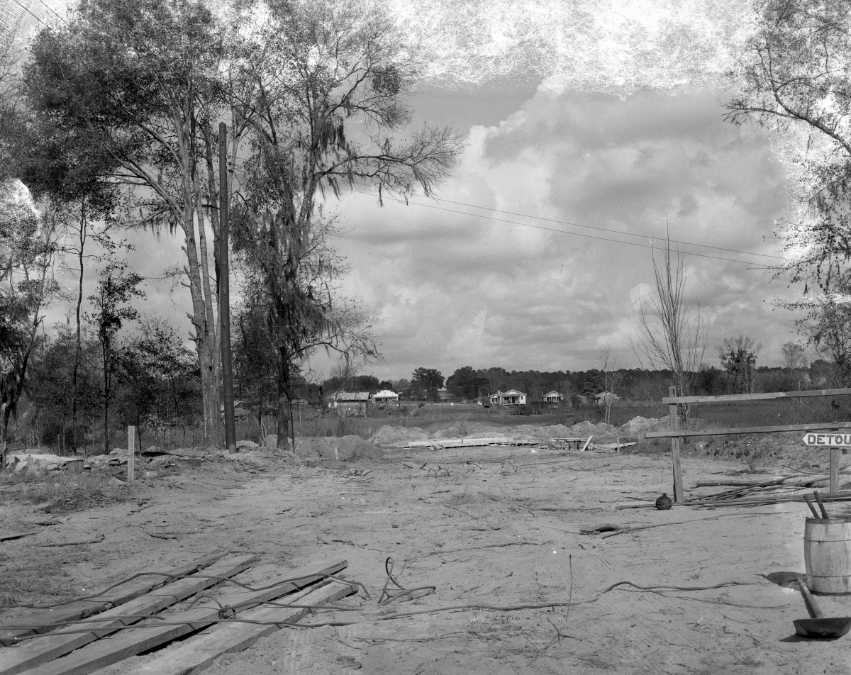 View of a street from an empty lot.