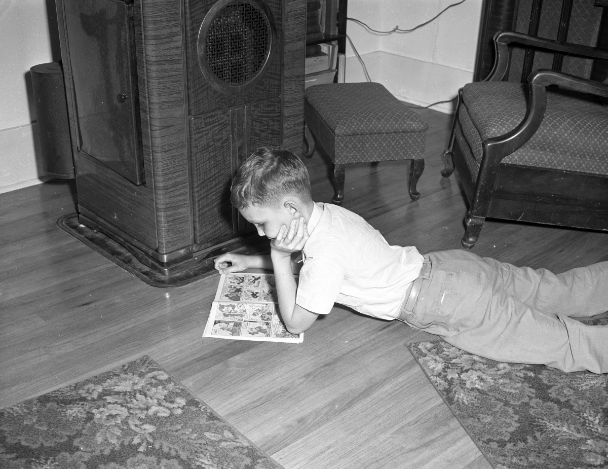 Ryan Edwards lying on the floor reading.
