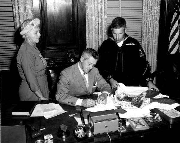 Governor LeRoy Collins signing Florida flag to be carried to the South Pole - Tallahassee, Florida.