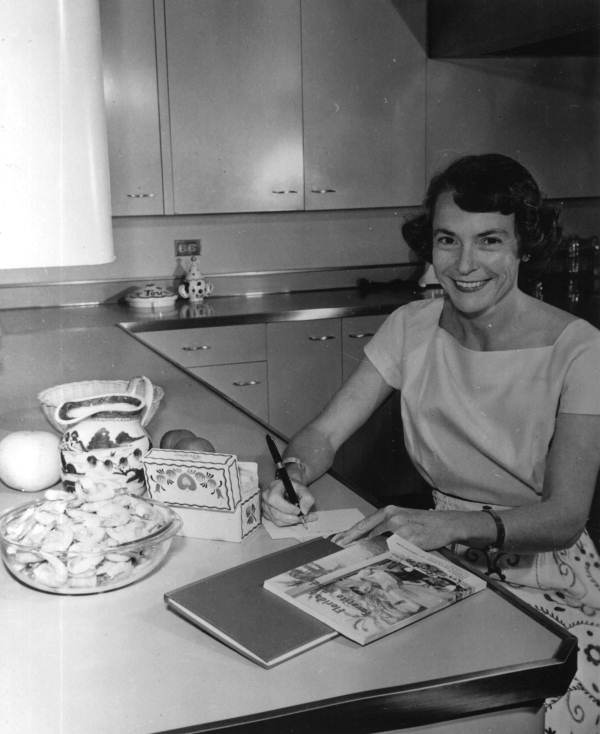 Florida's first lady Mrs. LeRoy Collins writing at kitchen counter - Tallahassee, Florida.