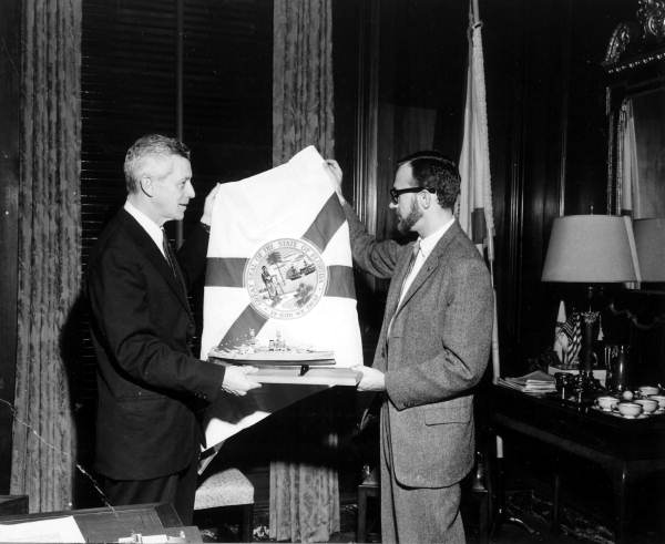 Governor LeRoy Collins presenting official state flag in exchange for memorial model - Tallahassee, Florida.