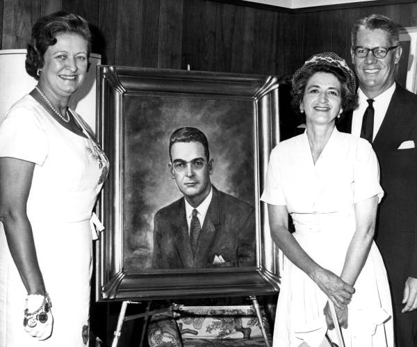 Family members and artist pose with painted portrait of Governor McCarty - Tallahassee, Florida.