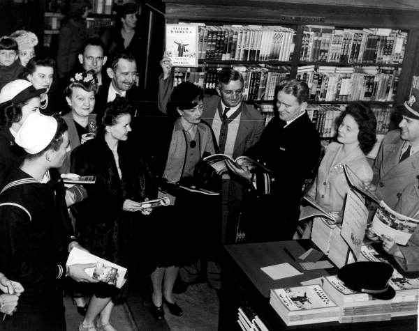 Lieutenant Fuller Warren autographing copies of his book - Jacksonville, Florida