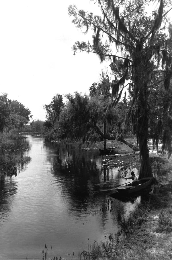 Man with rowboat in Dora Canal