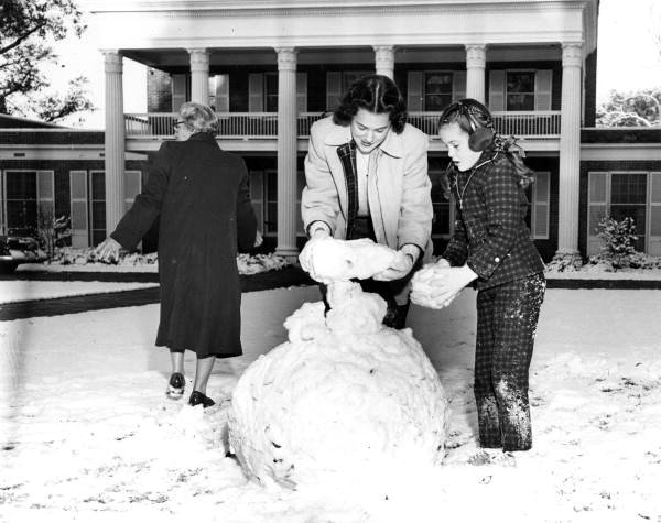 Governor's daughters Mary Call and Darby Collins build a snowman on the mansion lawn - Tallahassee, Florida.