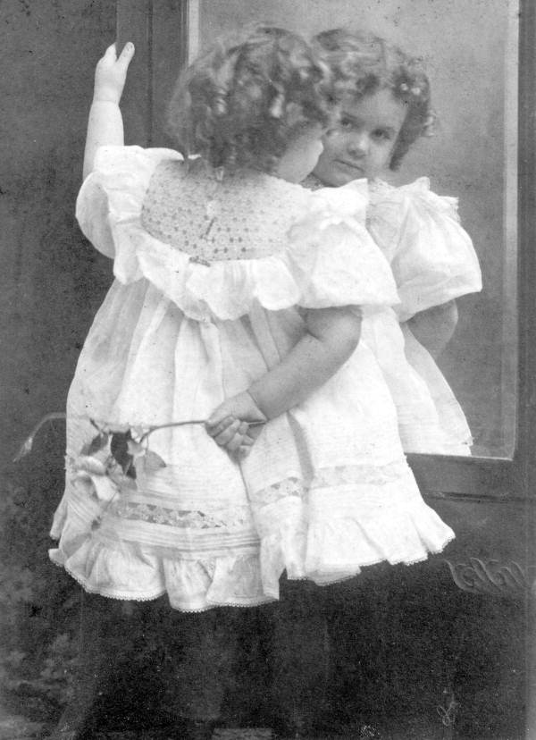 Annie Collins Houstoun looking at herself in mirror - Tallahassee, Florida.