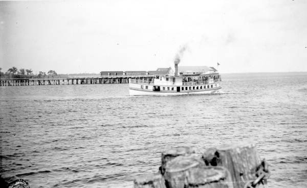 Steamboat "Clara" sailing past a dock on Lake Monroe - Sanford, Florida.