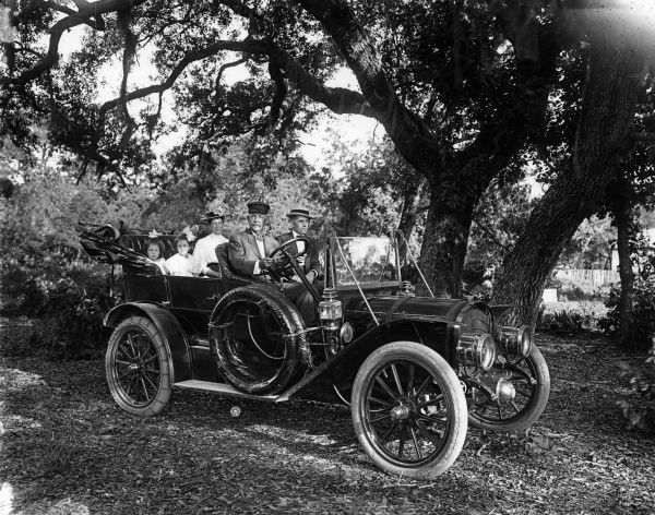 Cottrell family with friend in a Premier Touring car - Pensacola, Florida.