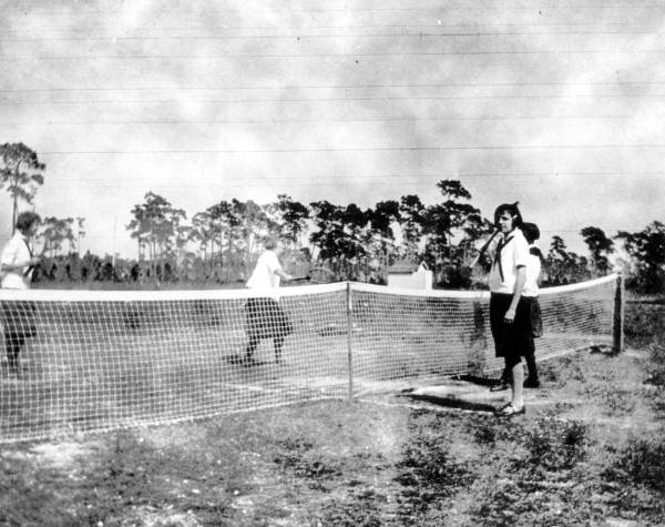 Tennis on dirt court at Alva School.