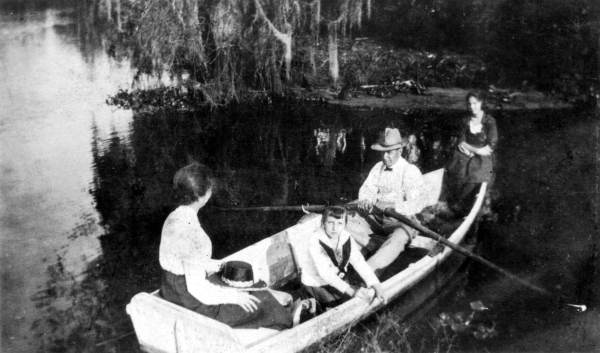 Group of people in a rowboat on the Caloosahatchee River