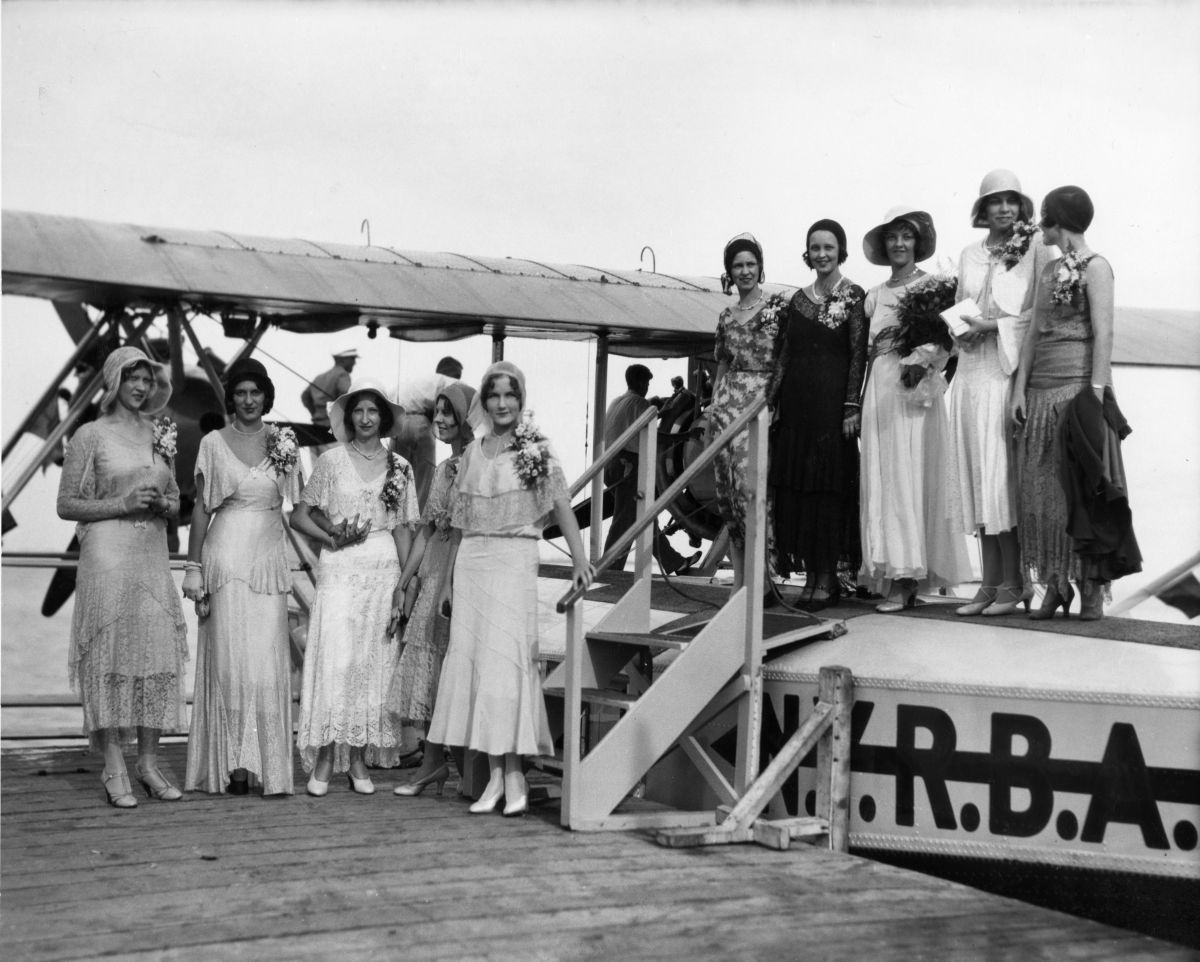 Young women at the first flight of an airline's seaplane.