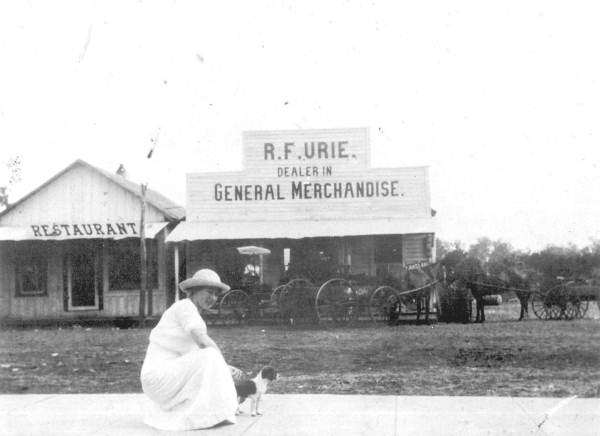 Ruth Maxcy Urie and puppy in front of the family store - Frostproof, Florida