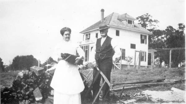 "Uncle Al" and Ruth Pollard in their back yard fetching wood for the stove - De Land, Florida