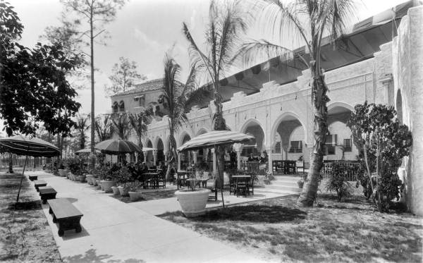Men seated outdoors at the Antilla hotel - Coral Gables, Florida