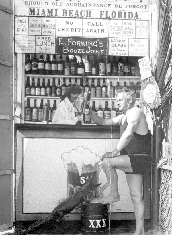 Man with a drink in a tourist photo booth at Hardie's Bathing Casino during the prohibition - Miami Beach, Florida.