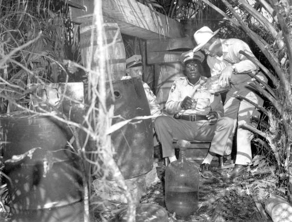 Police testing moonshine after raid - Immokalee, Florida.