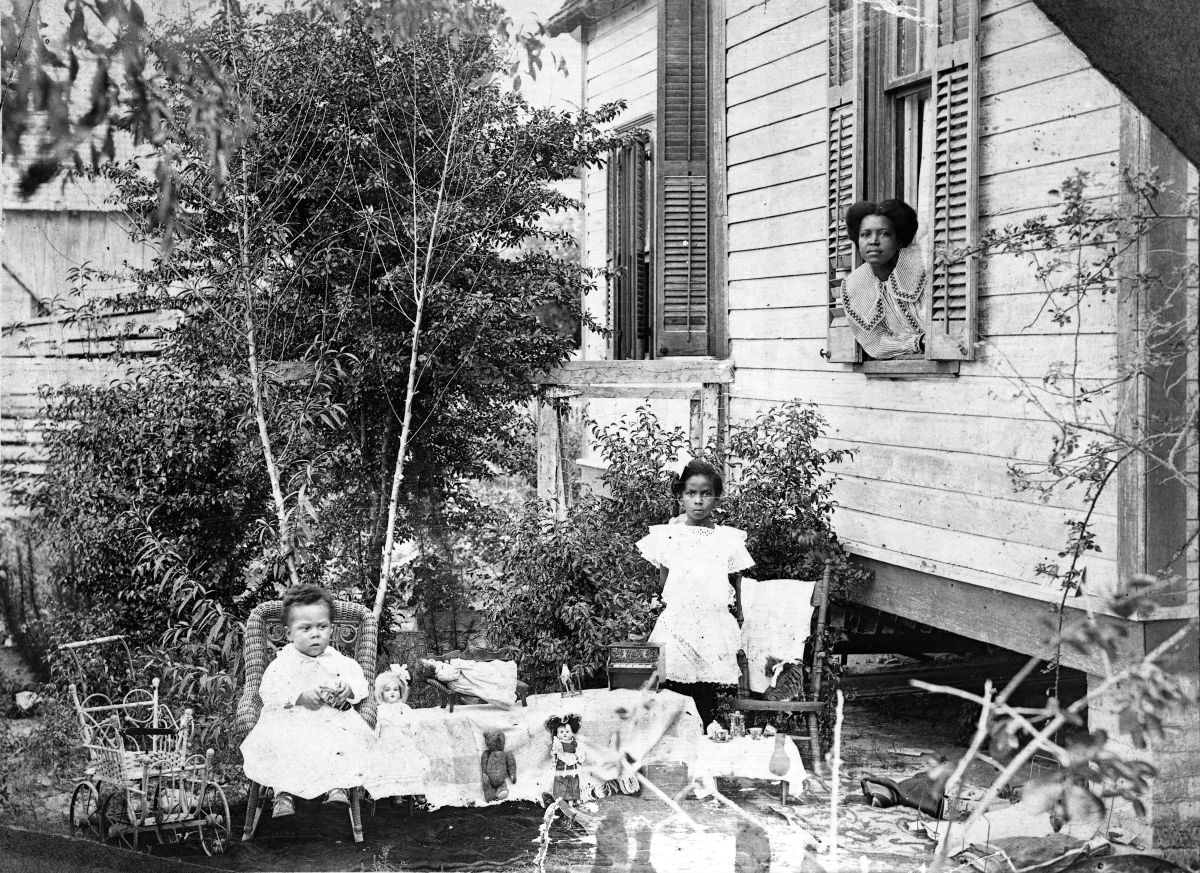 Young girls posed with their toys - Gainesville, Florida.