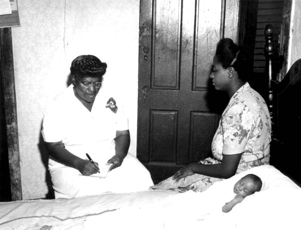 Midwife checking on newborn and new mother - Duval County, Florida