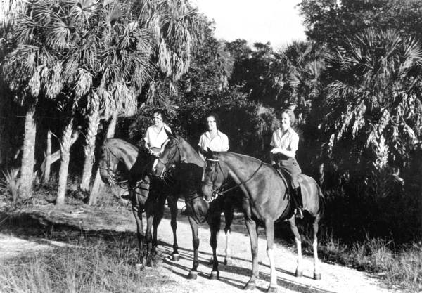 Young women riding horses