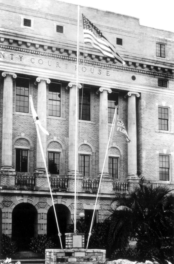 Flags flying in front of the Lake County Courthouse - Tavares, Florida.