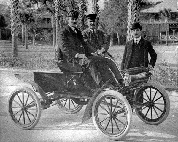 Three men with an Oldsmobile Curved Dash Runabout.
