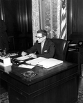 Governor Dan McCarty working at desk in his office - Tallahassee, Florida.