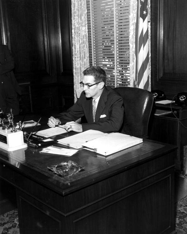 Governor Dan McCarty working at desk in his office - Tallahassee, Florida.