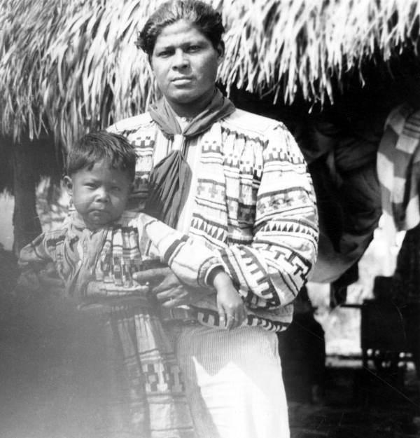 John Cypress holding his son Buck at a temporary camp in Immokalee, Florida.