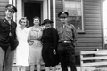 Midwife instructor Julia Graves, wearing black, standing with a group of people during World War Two.