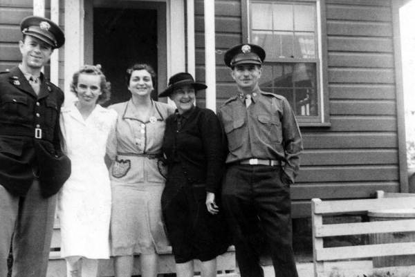 Midwife instructor Julia Graves, wearing black, standing with a group of people during World War Two.