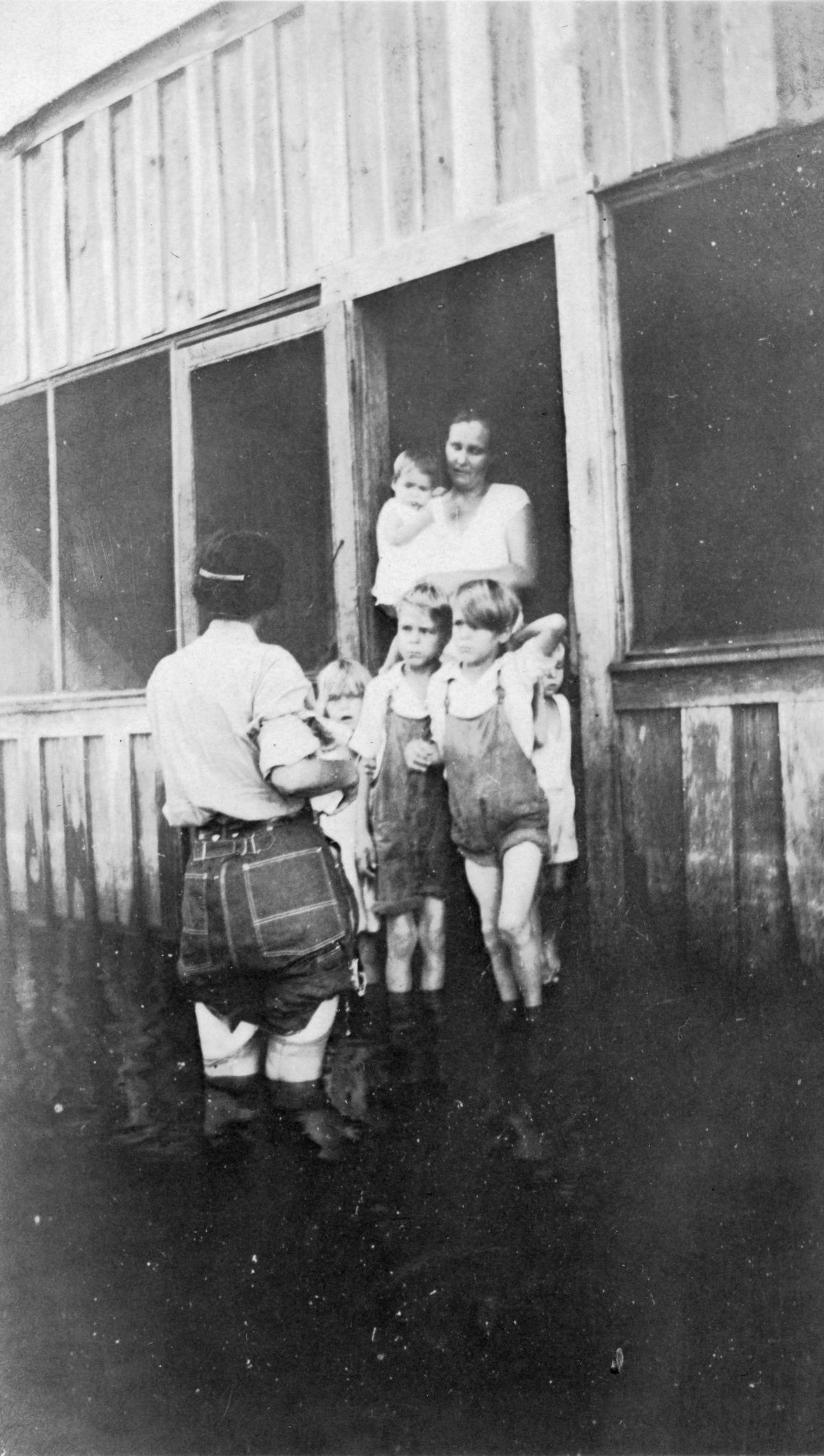 Public health nurse Jule Graves visiting with family during flood in LaBelle, Florida.