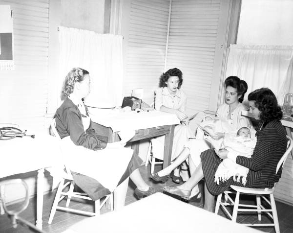 Public health nurses advising mothers on child care in Tampa, Florida.