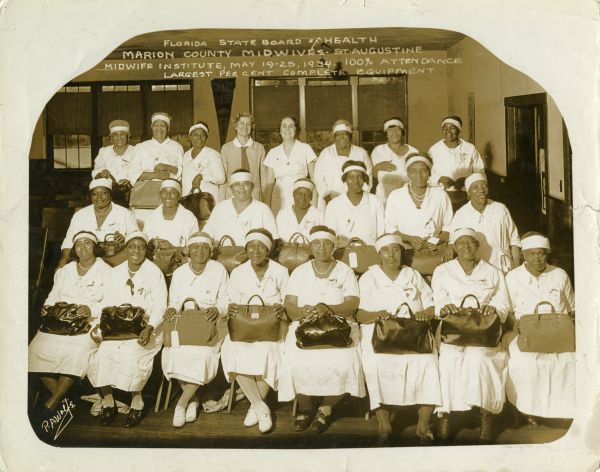 Group portrait of Marion County midwives at the Florida State Board of Health Midwife Institute in St. Augustine, Florida.