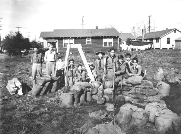 Boy Scouts building a bomb shelter.