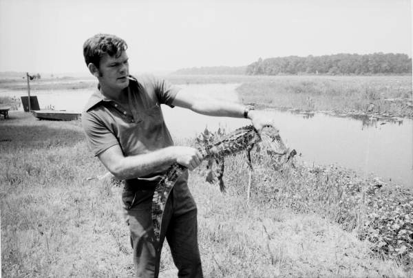 Unidentified TFD firefighter holding a baby alligator in Tallahassee, Florida.