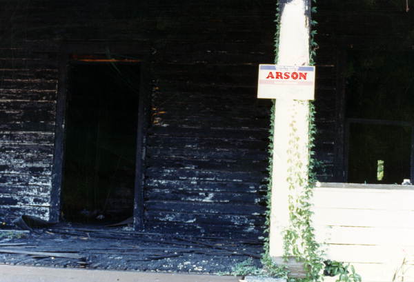 View showing a fire damaged house with an arson sign posted - Tallahassee, Florida.