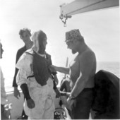 Treasure hunter Burt Webber being suited up by unidentified man