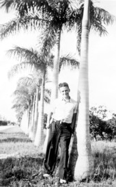 Treasure hunter Art McKee leaning against palm while posing for portrait