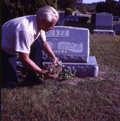 Art McKee placing flowers at his father's grave