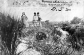 Deaconess Bedell and a Mikasuki woman walking in the Everglades