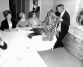 People at a fashion council admiring dresses